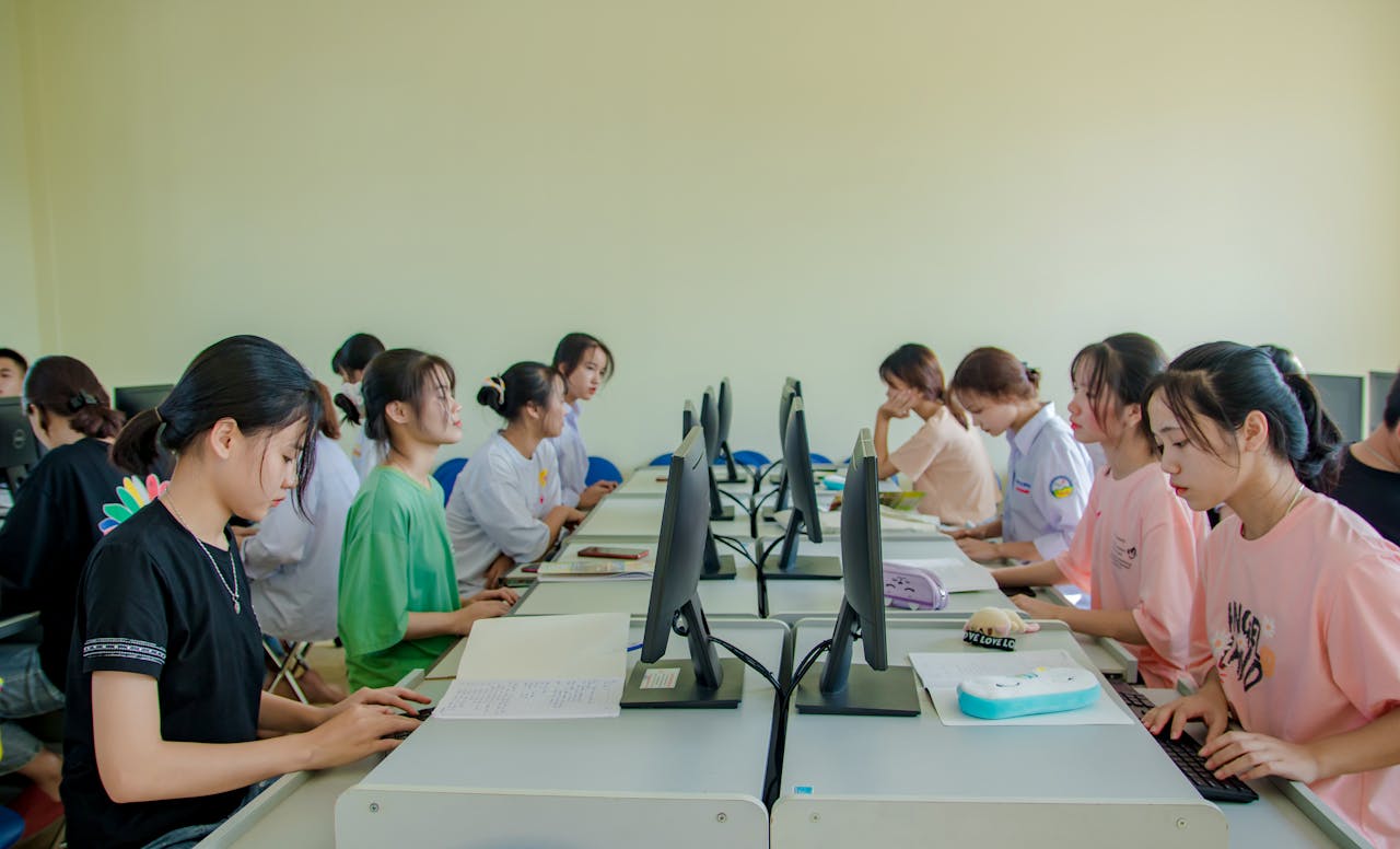 home-hero Group of female students studying at computers in a classroom setting.